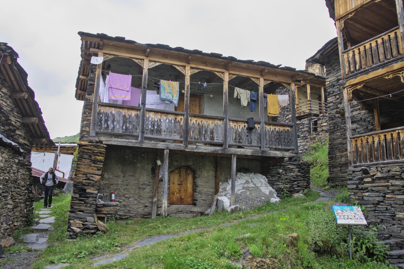 A stone guesthouse with a wooden balcony in the village of Dartlo in Tusheti